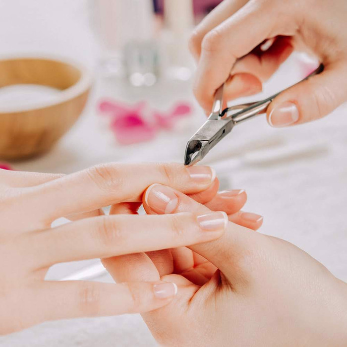 Người phụ nữ xem lịch hoặc giấy ghi chép để xác định nên cắt móng tay ngày nào theo quan niệm truyền thống.